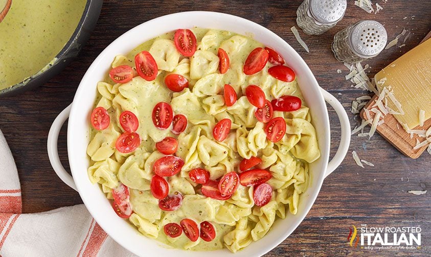 baked pesto tortellini topped with halved grape tomatoes