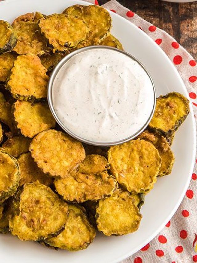 plate of fried pickle chips with creamy dipping sauce