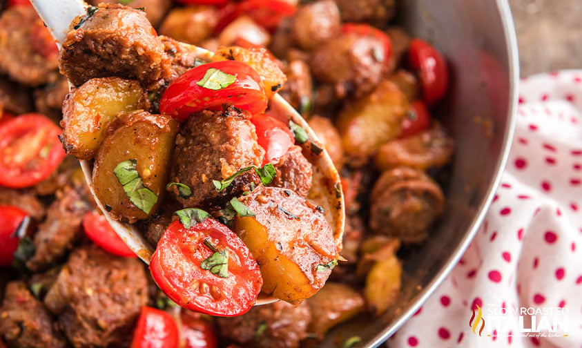 close up: fried potatoes and sausage with tomatoes