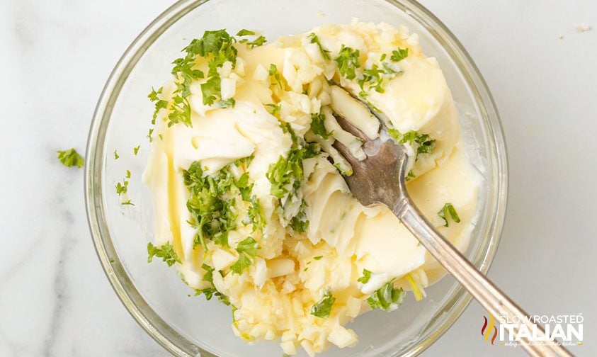 mixing herbed butter for garlic bread in air fryer