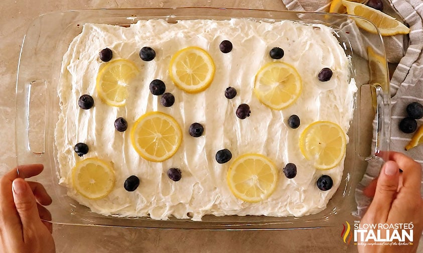 frosted sheet cake topped with blueberries and lemon slices