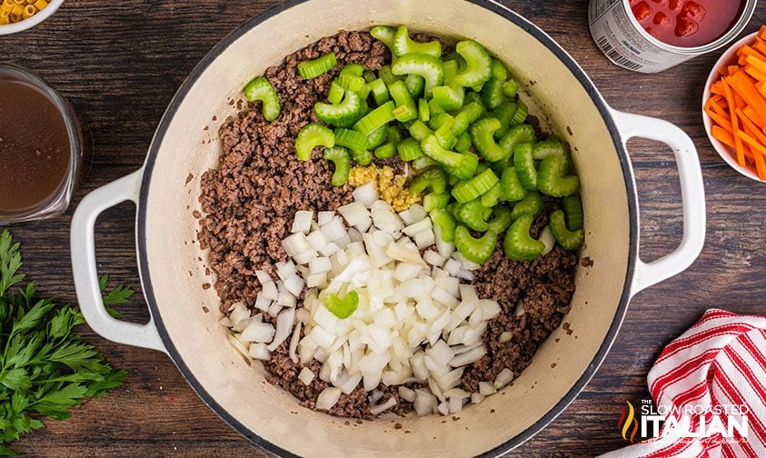 ground beef, onions, and celery in a Dutch Oven