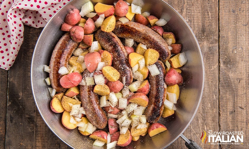 overhead of sausage, potatoes, and veggies in a skillet