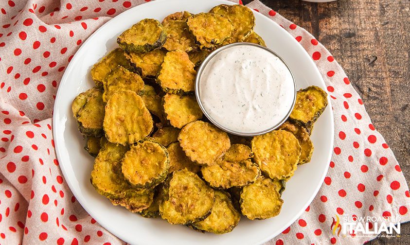 plate of fried pickle chips with creamy dipping sauce