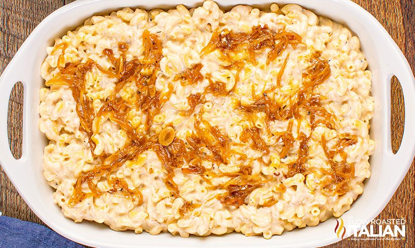 mac and cheese in casserole dish topped with caramelized onions