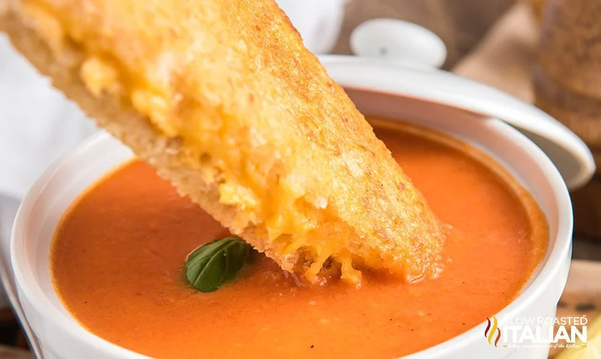 dipping air fried grilled cheese in tomato soup