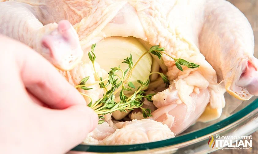 stuffing chicken cavity with onion and herbs