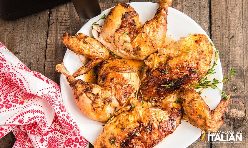 cooked and broken down whole chicken on plate