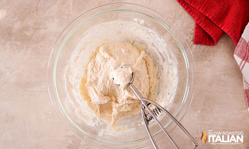 scooping dough to make chicken and Bisquick dumplings