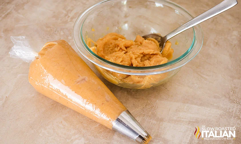 churro dough in a bowl and piping bag