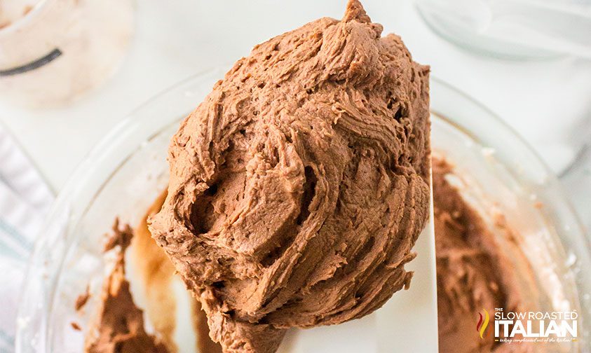 fluffy chocolate buttercream frosting on a rubber spatula