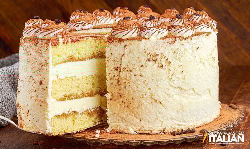 removing a slice of layered tiramisu cake