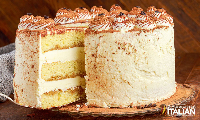 removing a slice of layered tiramisu cake