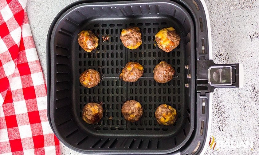 cooked cheesy meatballs in air fryer basket