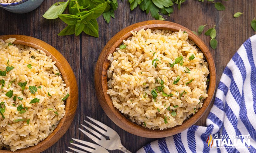 overhead: bowls of brown rice topped with parsley