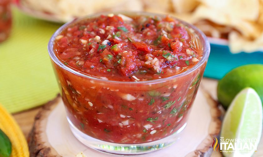 bowl of blender salsa surrounded by ingredients