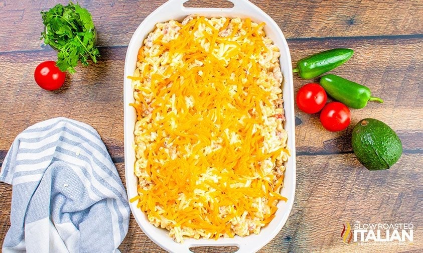 taco mac and cheese topped with shredded cheese in casserole dish