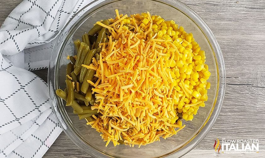 overhead: bowl of canned corn and green beans with shredded cheese