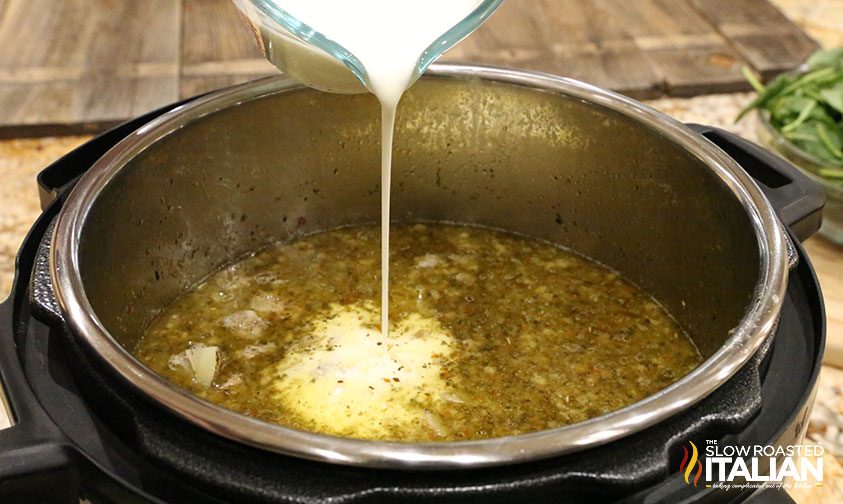 pouring heavy cream into instant pot soup