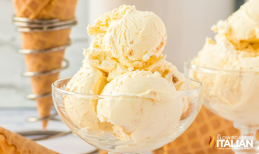 scoops of cheesecake ice cream in a glass bowl