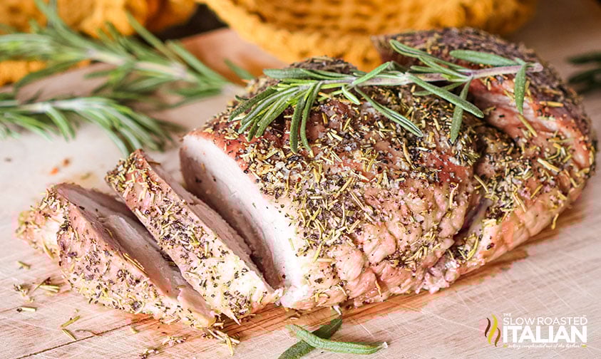 cooked boneless pork roast on cutting board