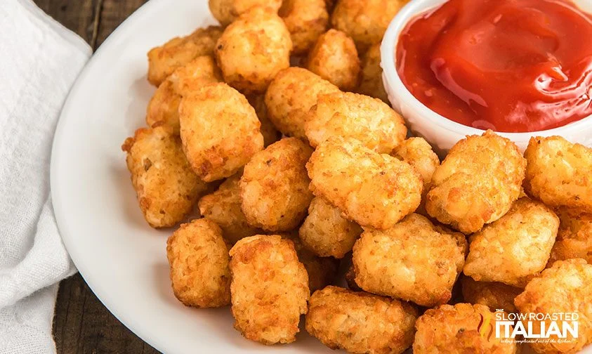 close up: plate of tater tots with ketchup