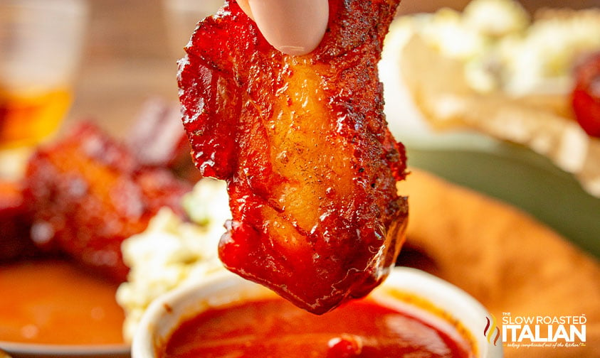 dipping pork burnt ends in sauce
