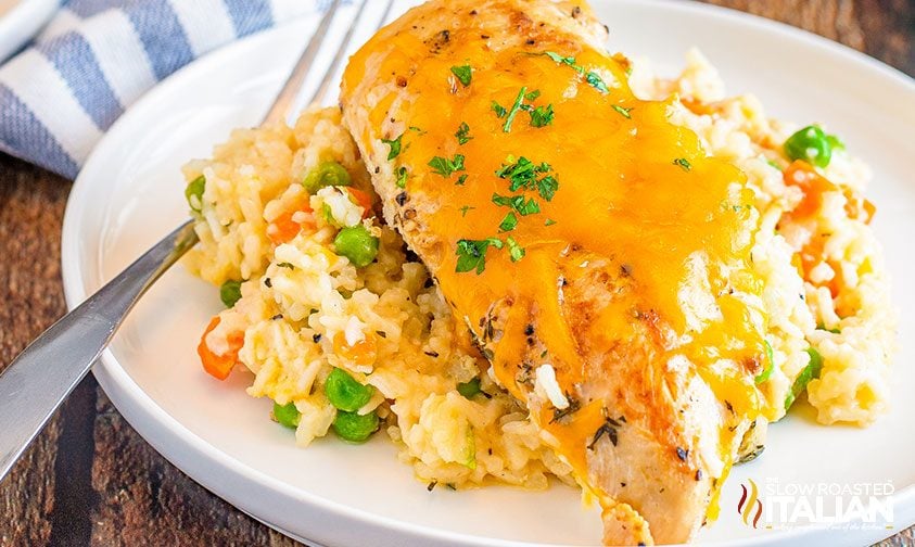 cheesy chicken breast over cooked rice and veggies