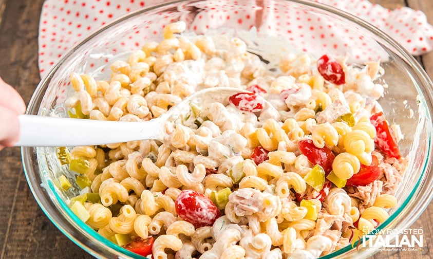 mixing dressing into tuna pasta salad