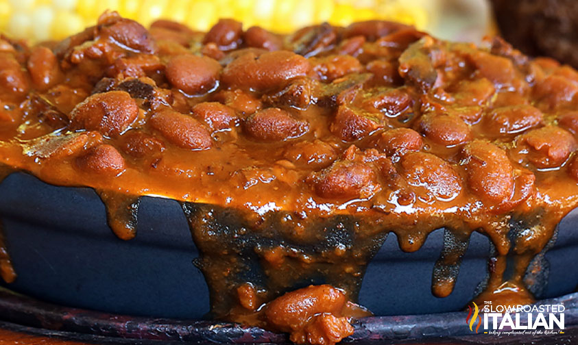 close up: baked beans with bacon in blue dish
