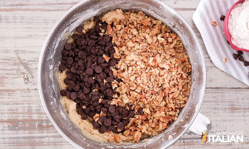 mixing chocolate chips and nuts into cookie dough