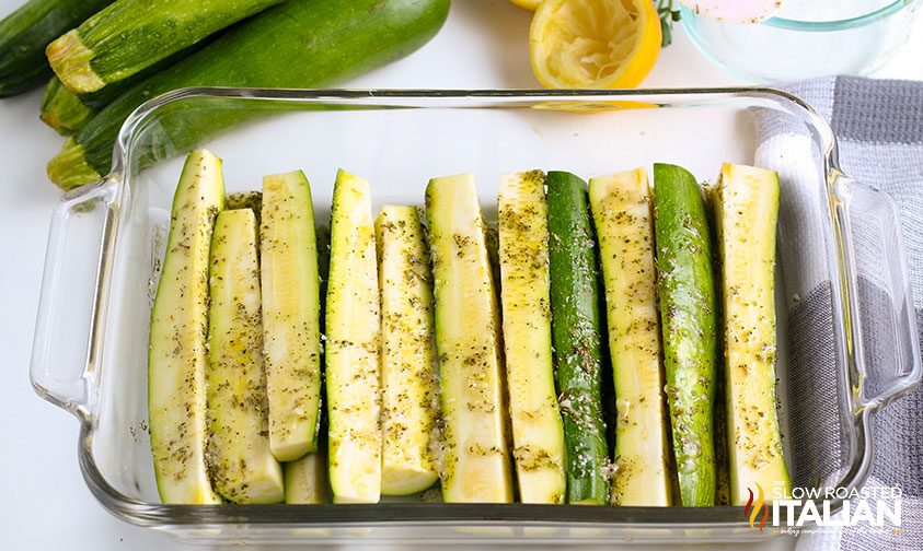 seasoned zucchini spears in glass dish