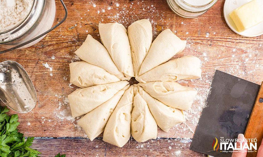 cutting breadstick dough with a bench scraper