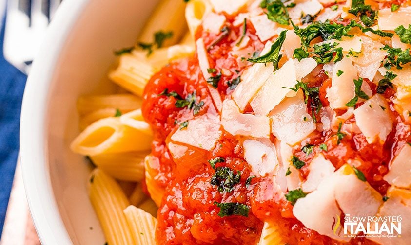 penne topped with tomato sauce and parmesan