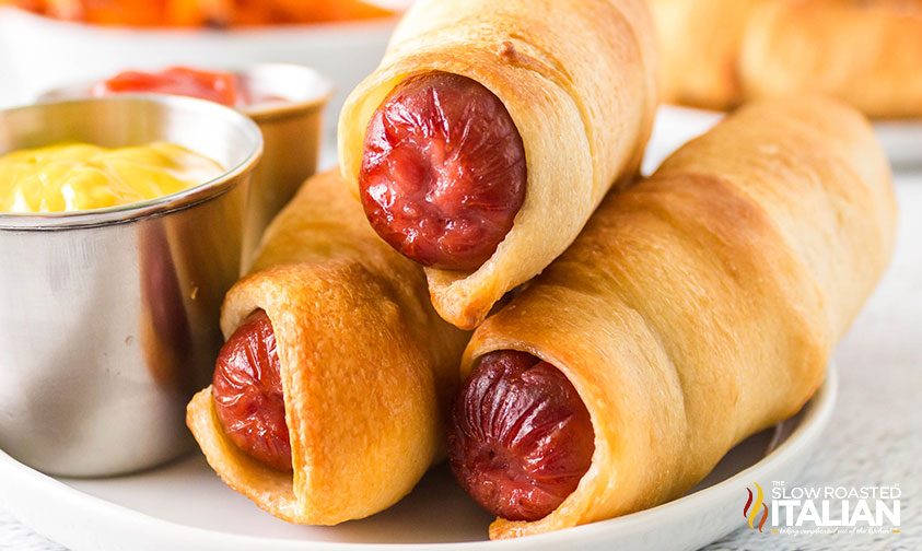 stack of pigs in a blanket with dipping sauces
