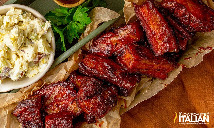 cooked pork burnt ends with potato salad
