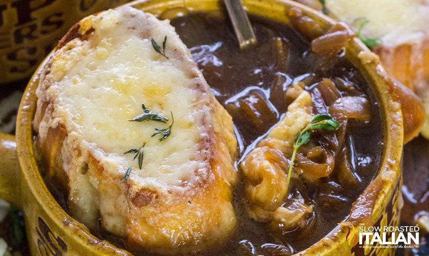 bowl of french onion soup with cheesy bread on top