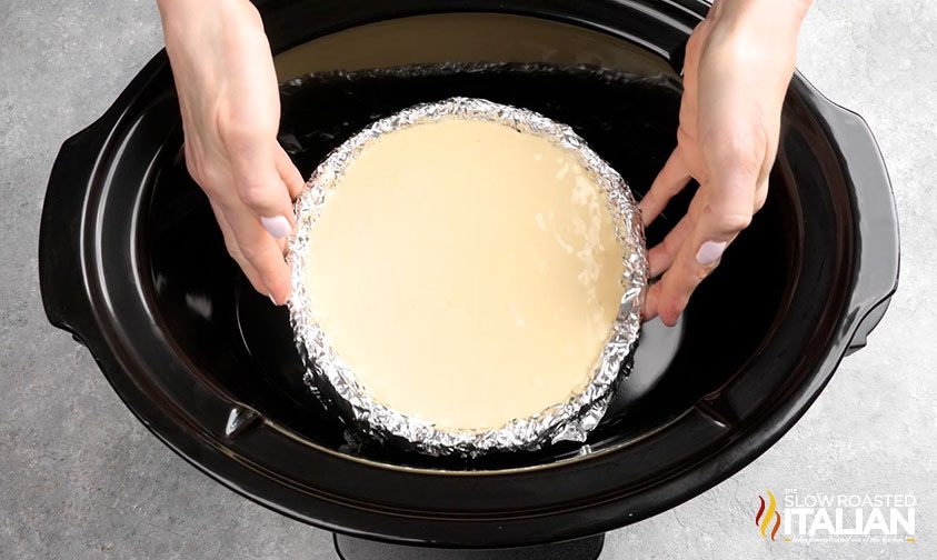placing cheesecake pan in slow cooker