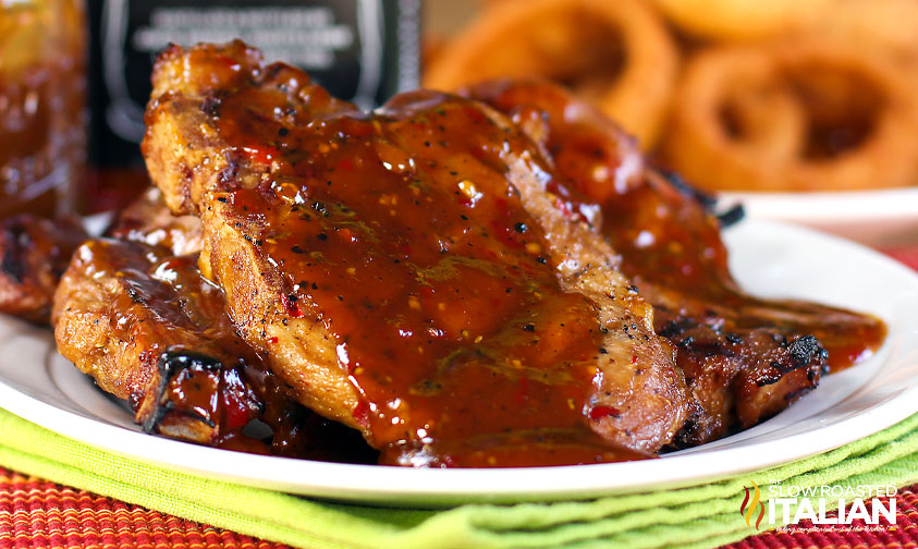 plate of grilled pork chops smothered in bbq sauce