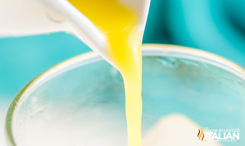 pouring orange juice into a glass