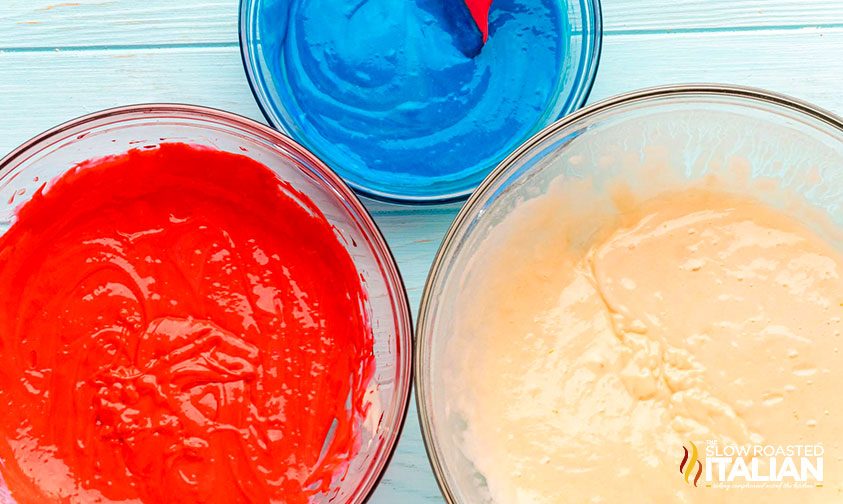 3 bowls of cake batter, one colored red and one colored blue