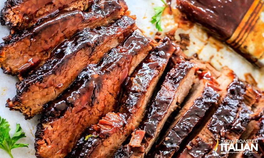 slices of slow cooked brisket with bbq sauce