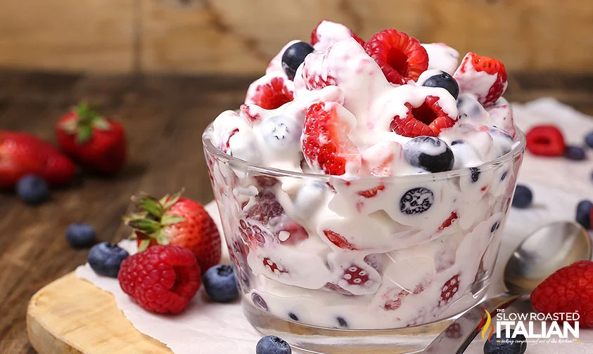 small glass bowl of berry cheesecake salad