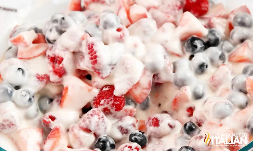 close up: cheesecake salad with strawberries, blueberries, and raspberries