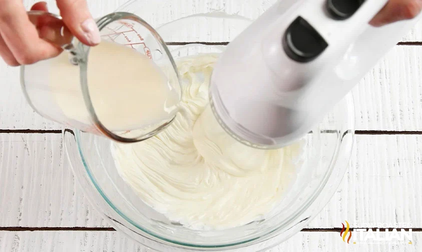 pouring creamer into whipped cream cheese