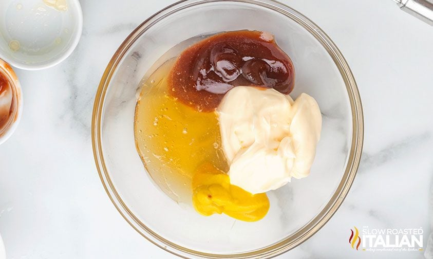 overhead shot of chick fil a sauce ingredients in a clear bowl