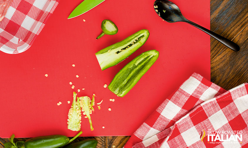 removing seeds and veins from halved jalapenos