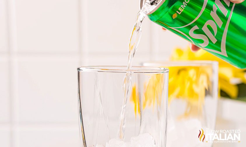 pouring Sprite from a can into a glass