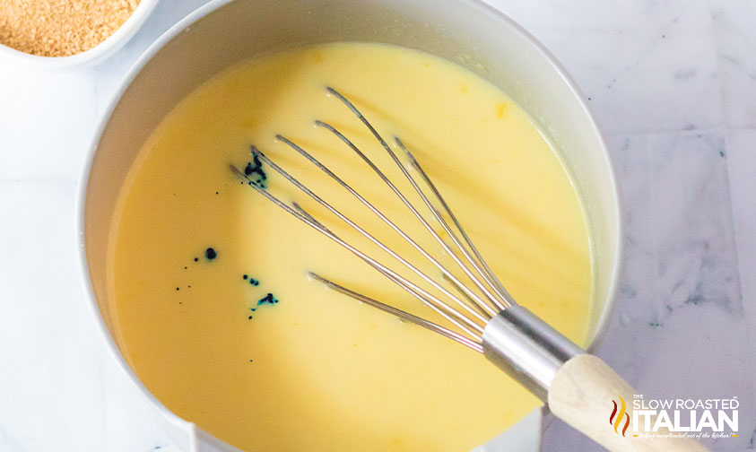 whisking blue food coloring into pudding shot base