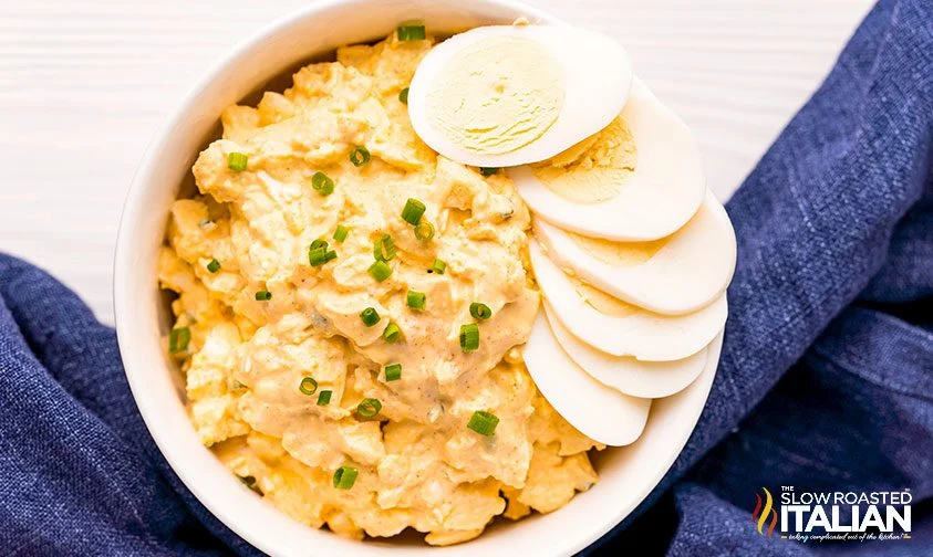 bowl of egg salad topped with sliced hard boiled eggs